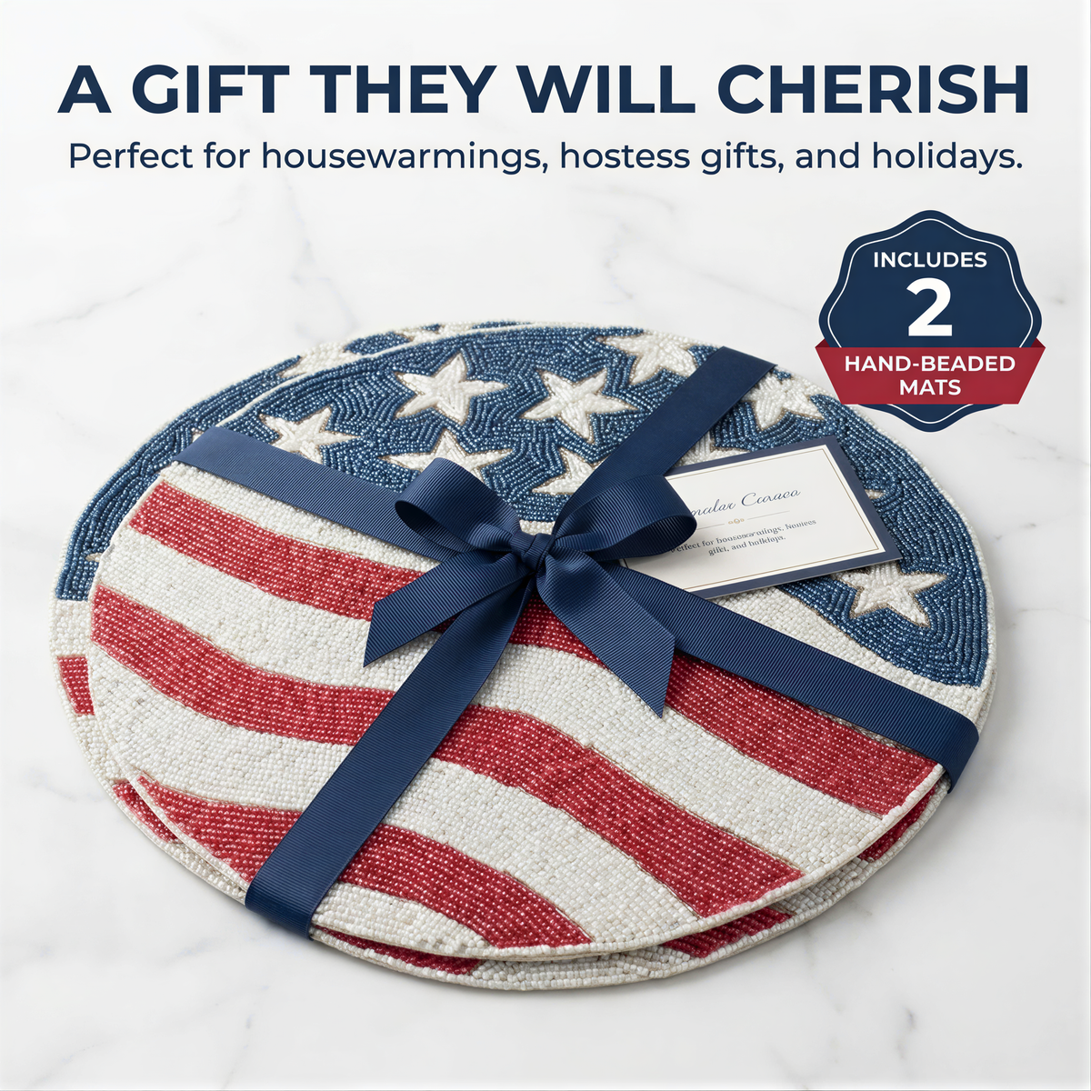 A gift wrapped in a blue ribbon, featuring a patriotic design of red, white, and blue stripes and stars, with a tag indicating it is a hand-beaded mat set.