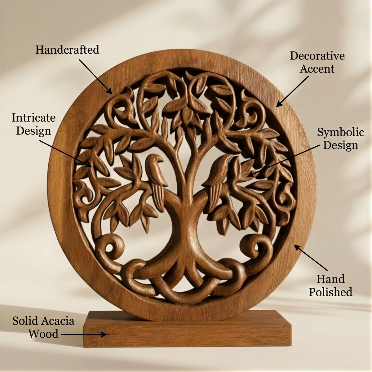 a handcrafted wooden tree carving with intricate designs, including leaves and birds, mounted on a wooden base.
