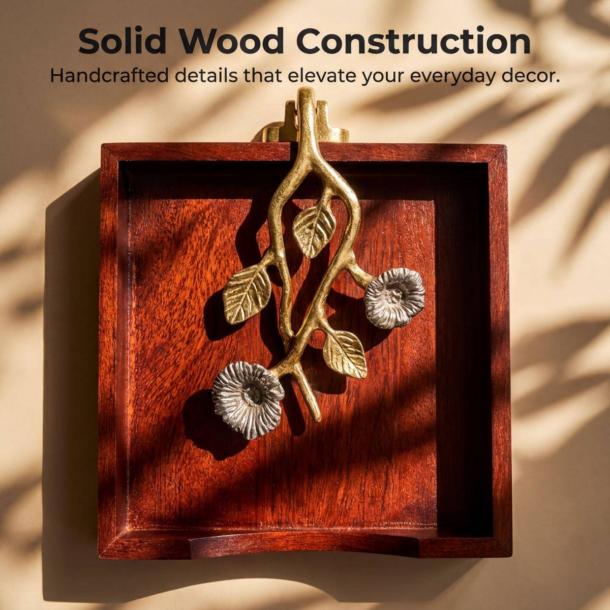 a wooden tray with a decorative metal piece hanging on it, which appears to be a piece of solid wood construction.