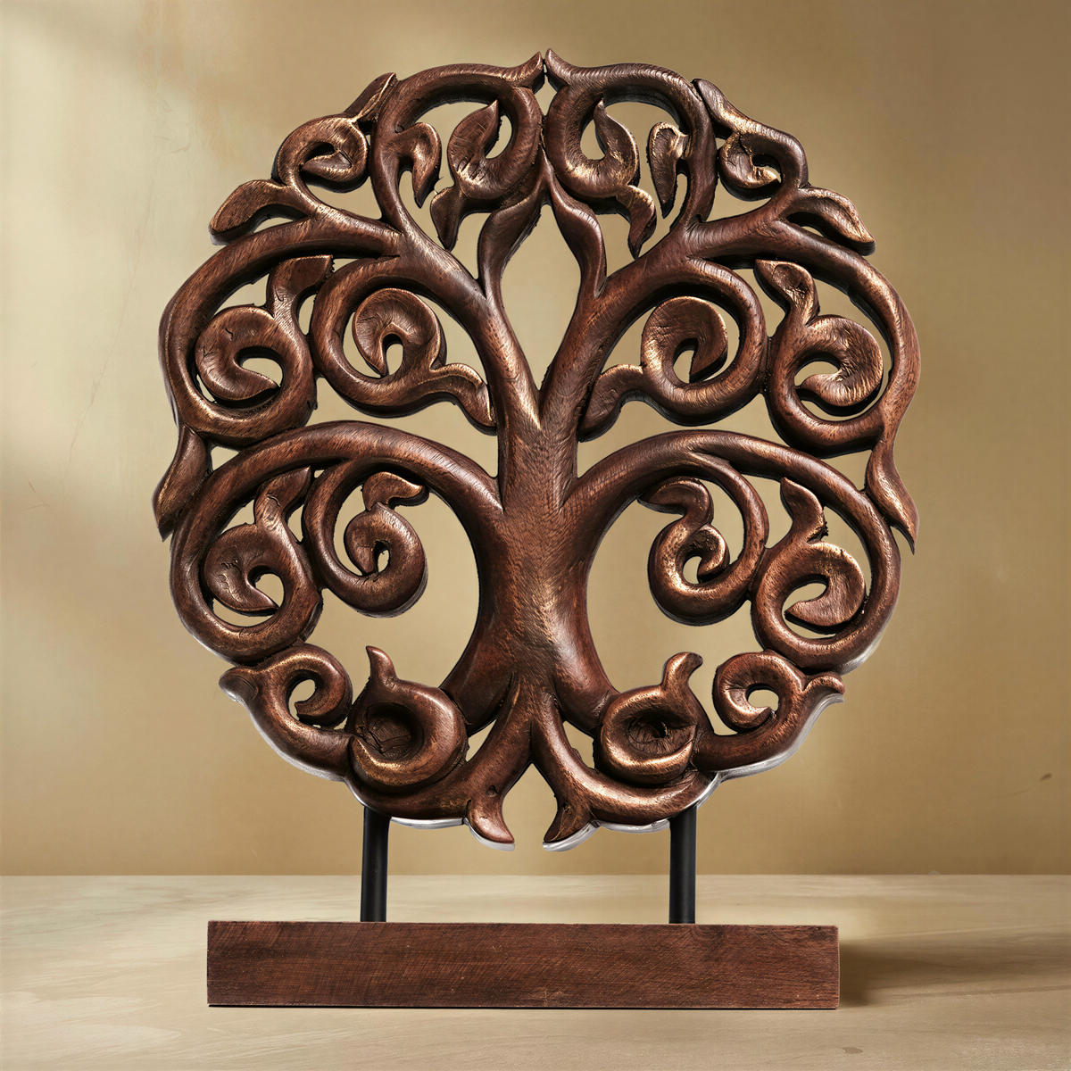 A beautifully crafted wooden tree sculpture with intricate carvings and patterns, displayed on a wooden stand.