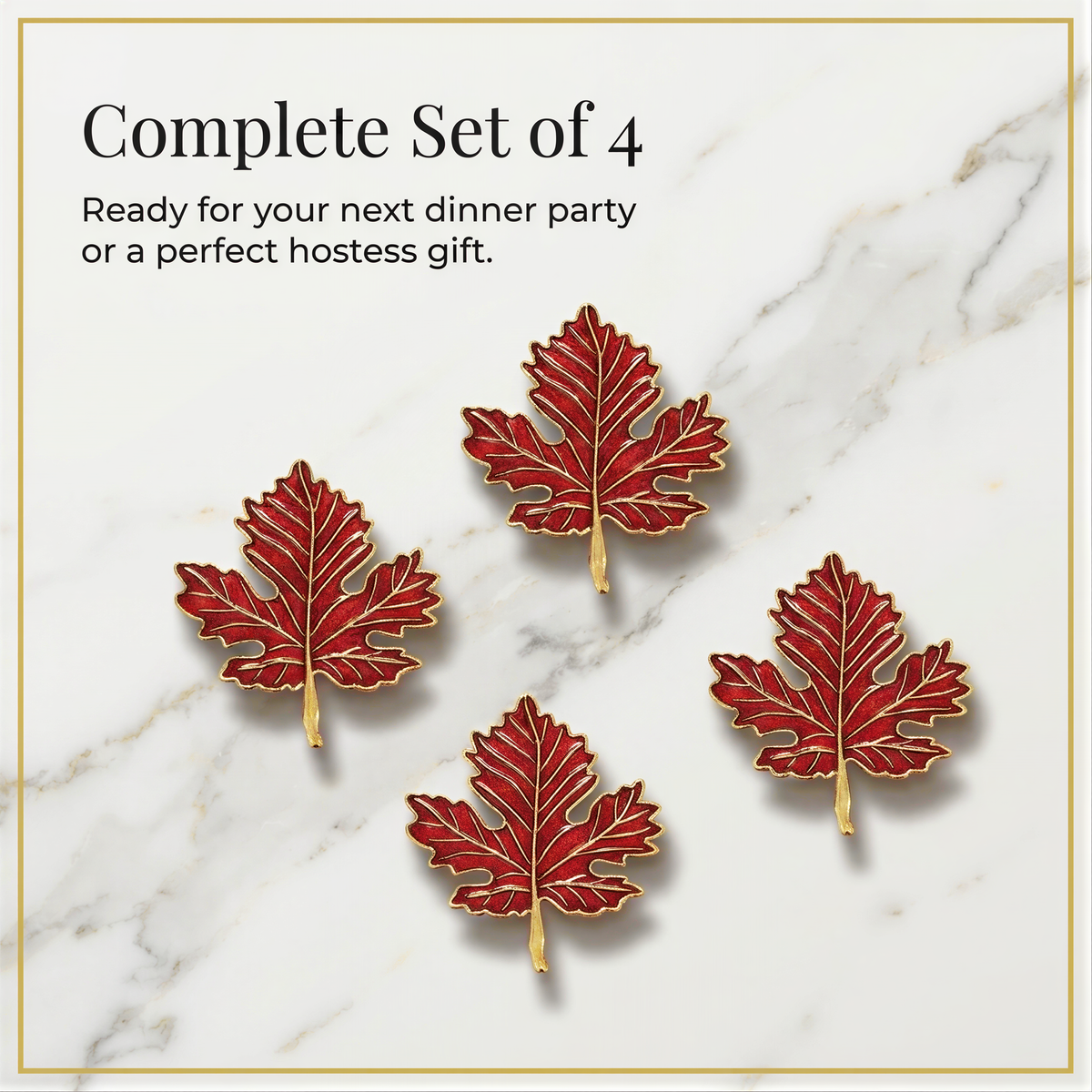 four red leaf-shaped pins arranged in a square formation on a marble surface.