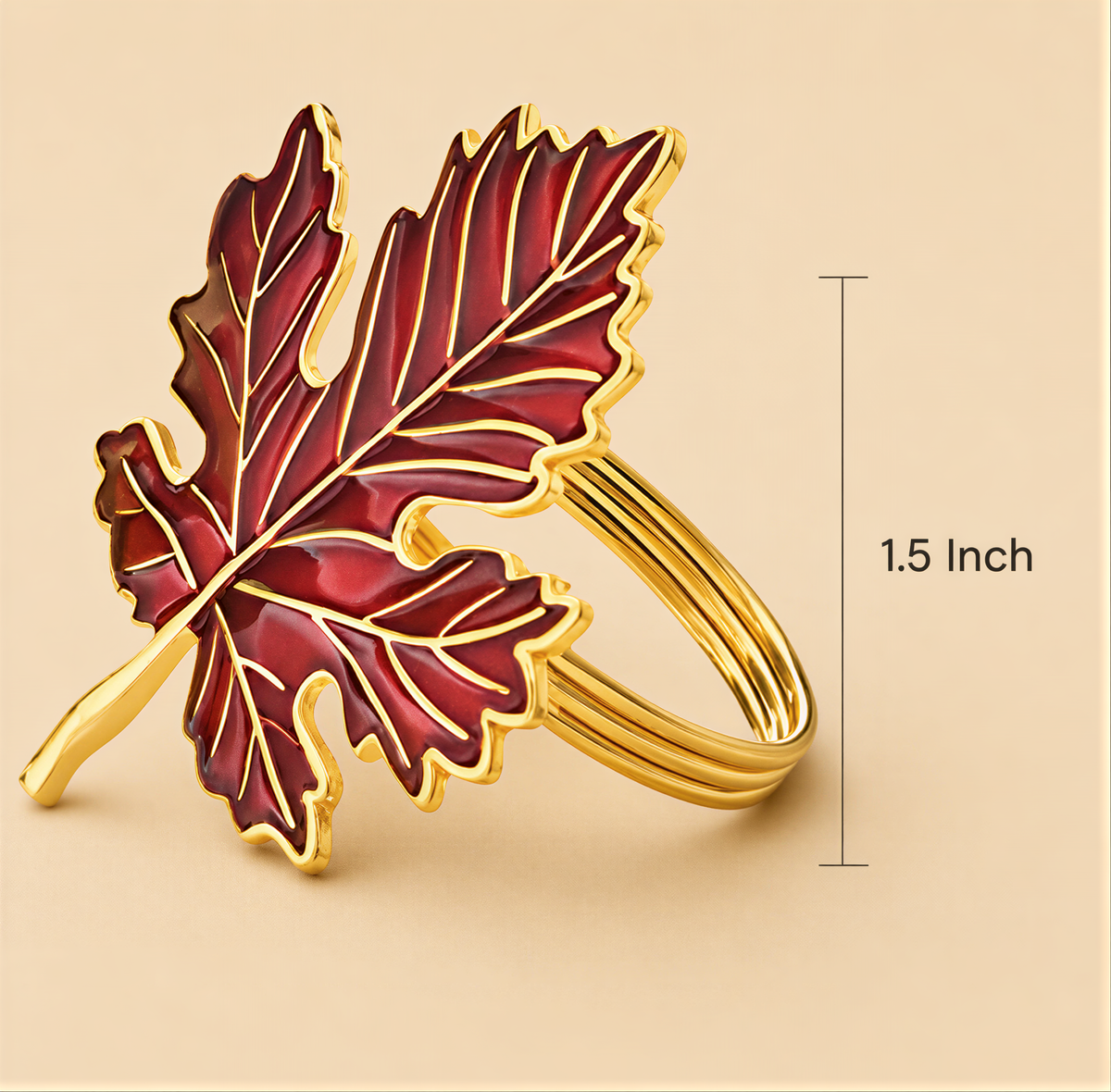 A close-up image of a decorative leaf-shaped ring made of gold, with a red and gold color scheme.