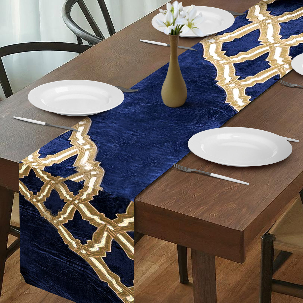 Embroidered decorative table runner by CU6047-RNR with intricate floral embroidery on a fabric table covering.