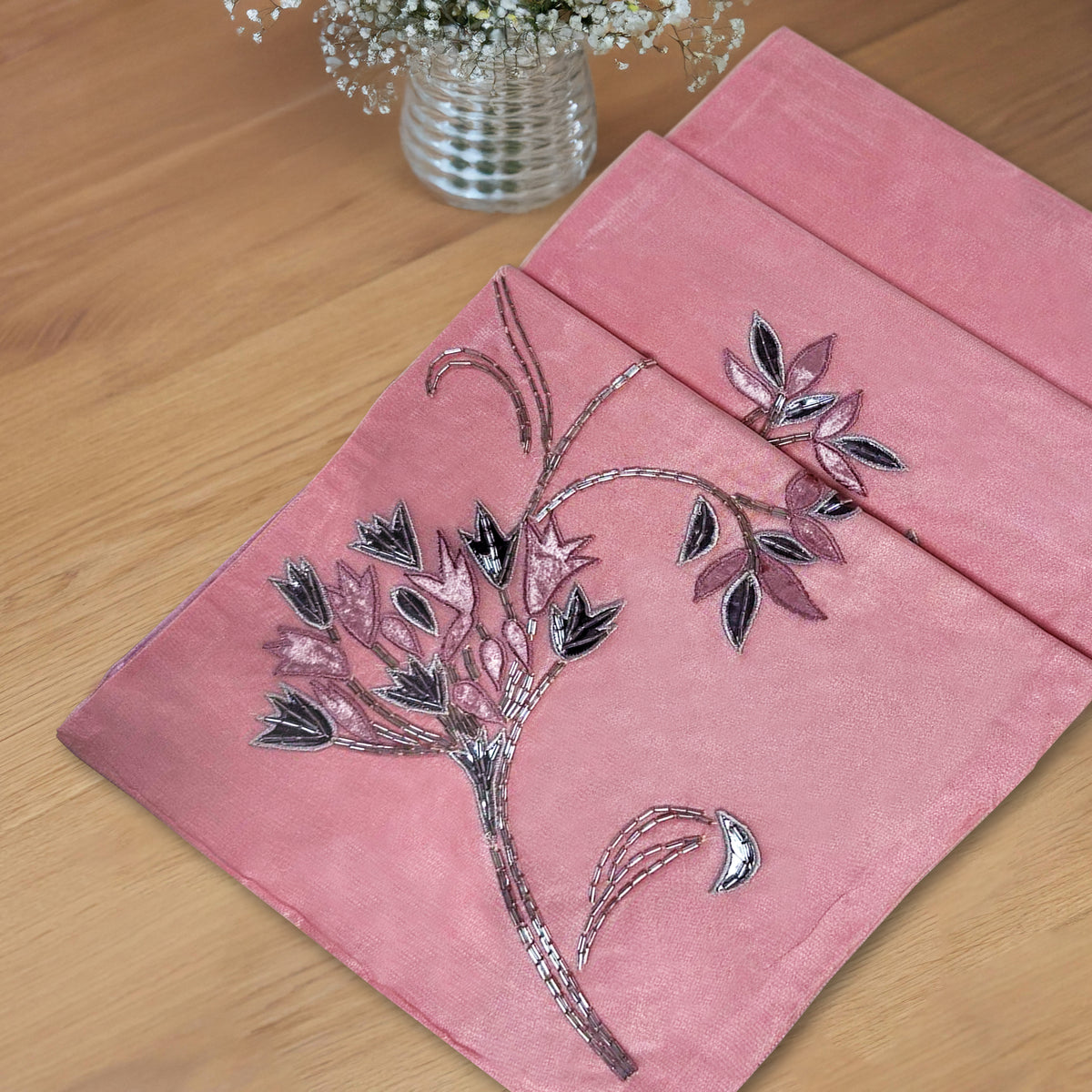 Embroidered decorative table runner from CU6409-RNR with intricate floral embroidery on fabric, ideal for elegant dining setups.