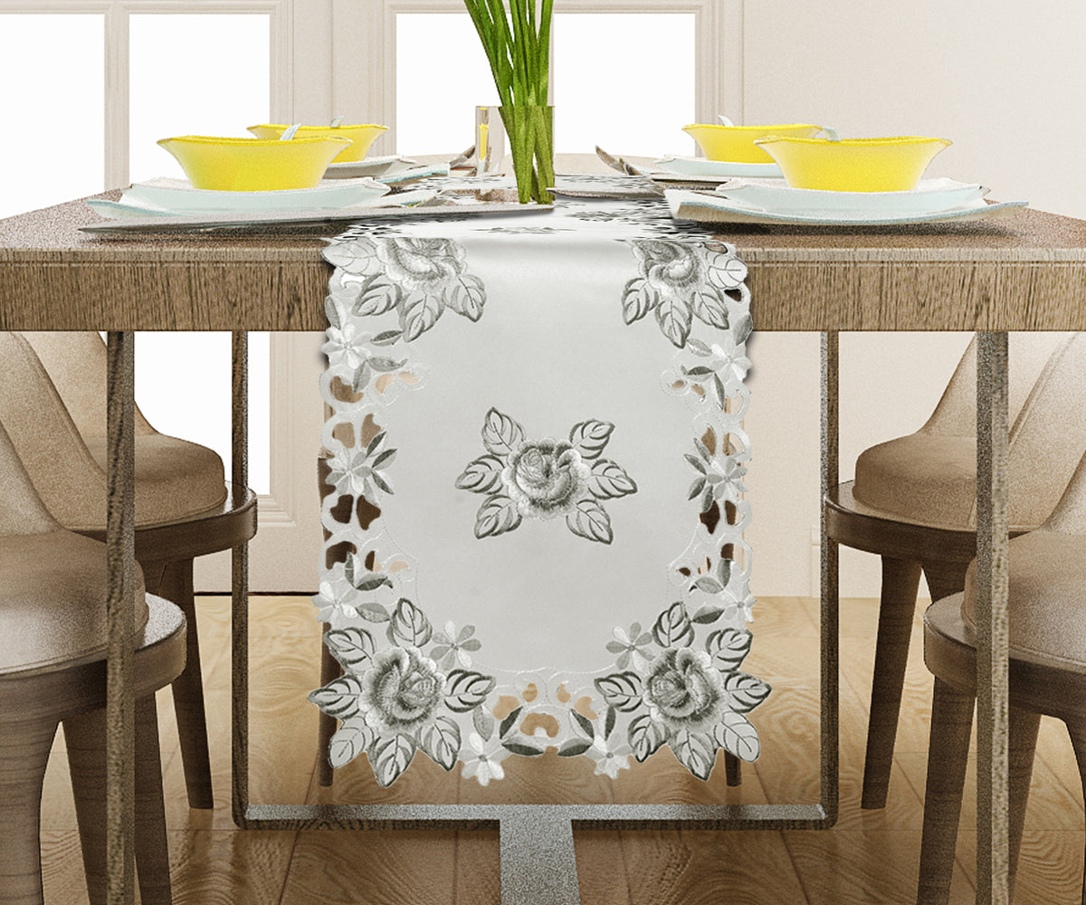 Linen table runner with intricate European embroidery, showcasing detailed craftsmanship on a stylish dining table.