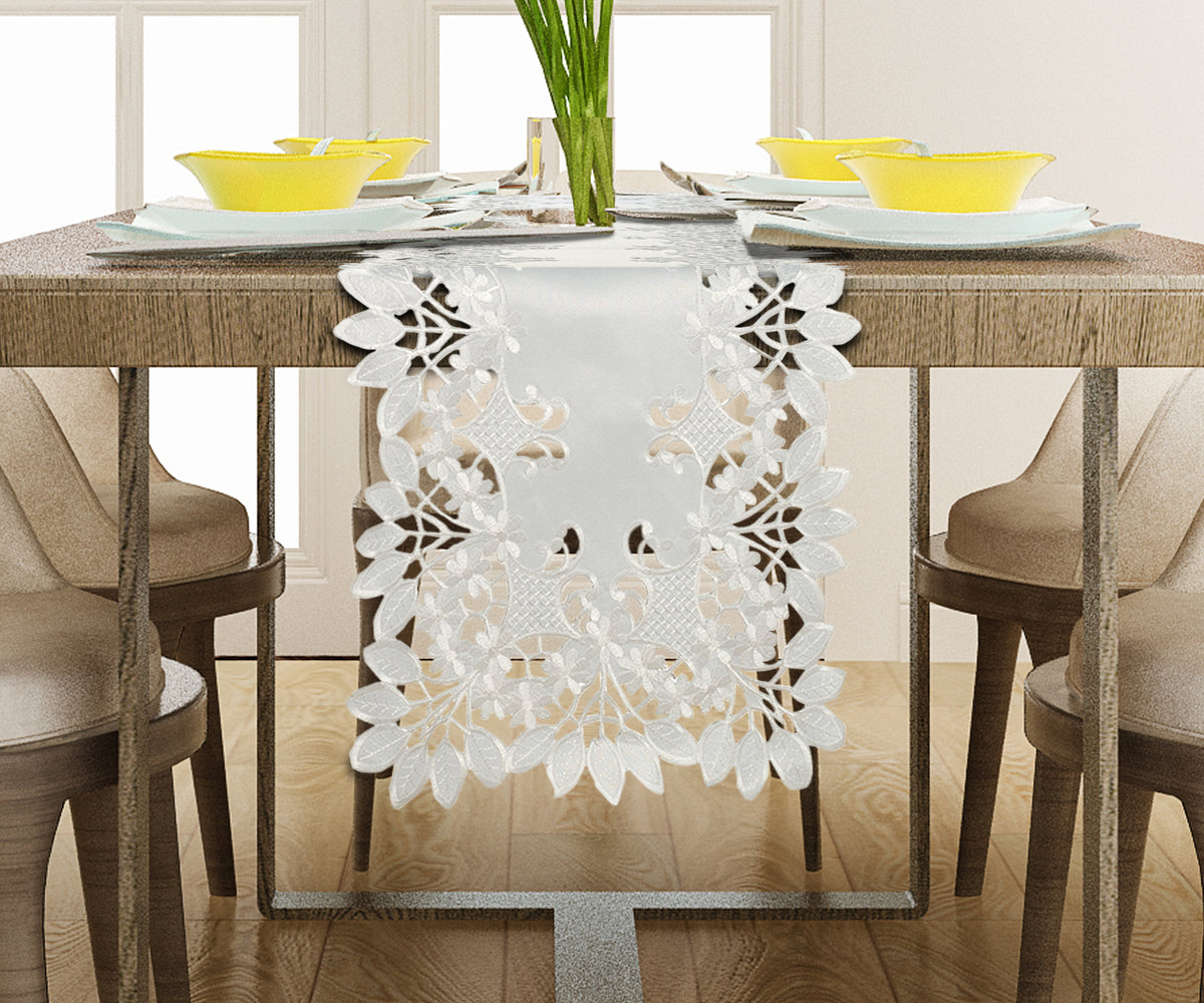 Linen table runner with intricate European embroidery from The Deandra Collection, showcasing detailed floral patterns.