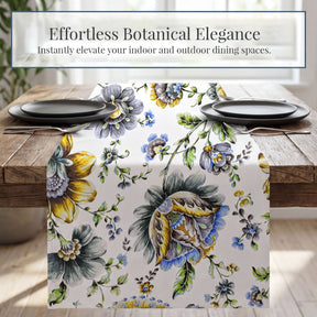 a table setting with a floral table runner, plates, and silverware.