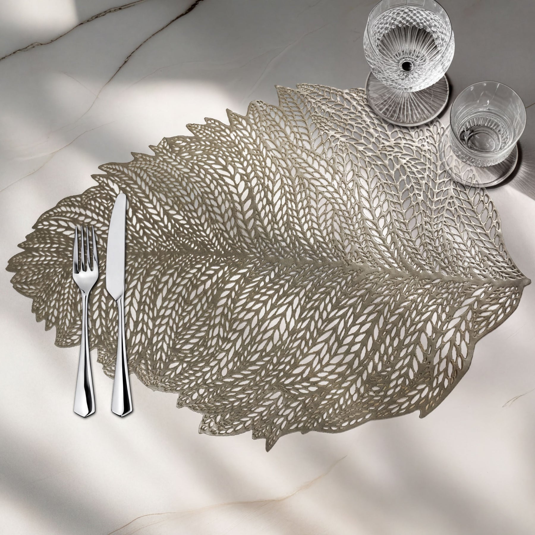 Set of six leaf-shaped vinyl placemats with cut-out design by AMF033-GLD for stylish table decor.