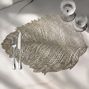 Set of six leaf-shaped vinyl placemats with cut-out design by AMF033-GLD for stylish table decor.