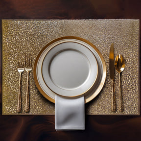 Set of six gold PVC cut-out placemats with intricate designs, perfect for protecting tables and adding style.