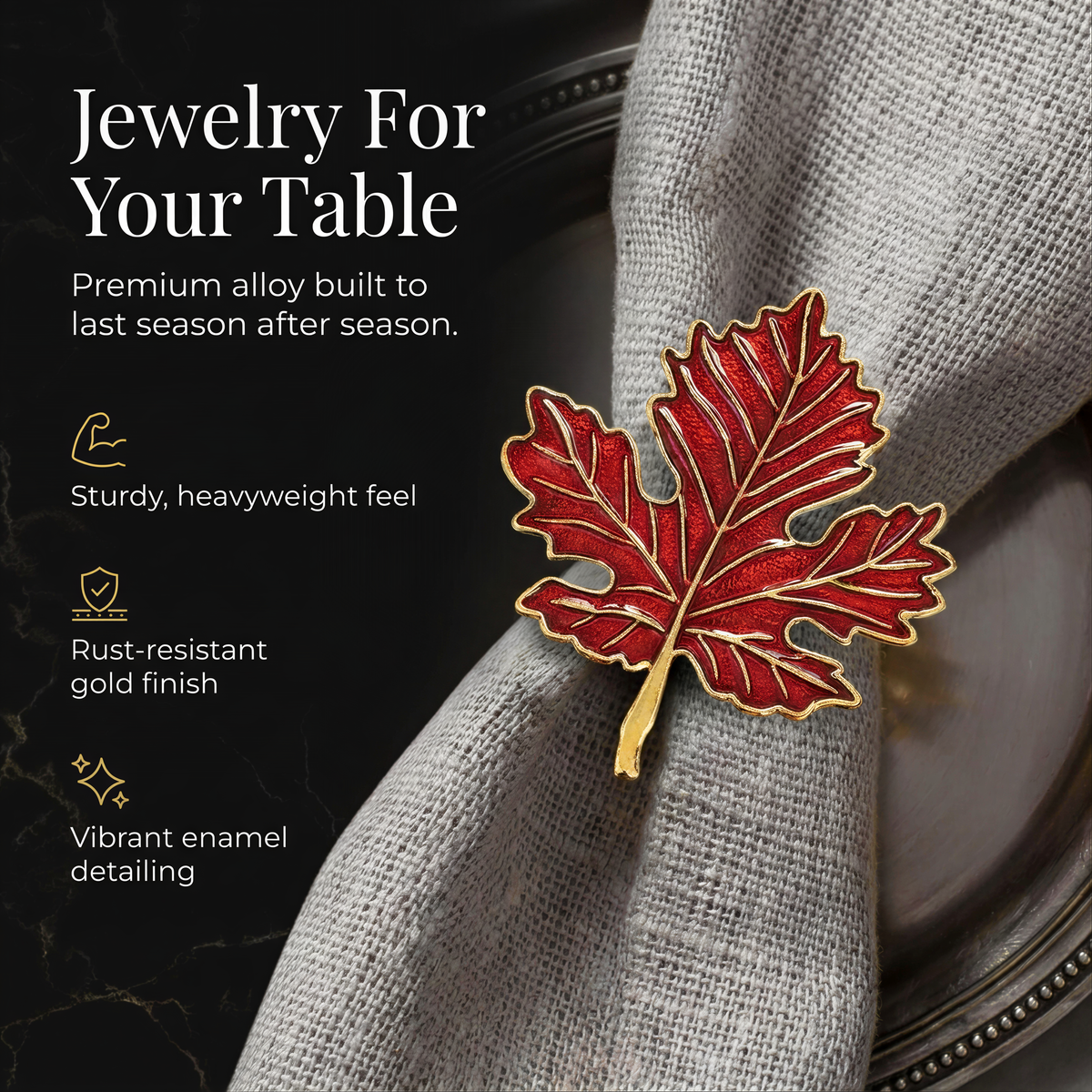 a red leaf-shaped napkin ring on a gray fabric napkin, with a black background.