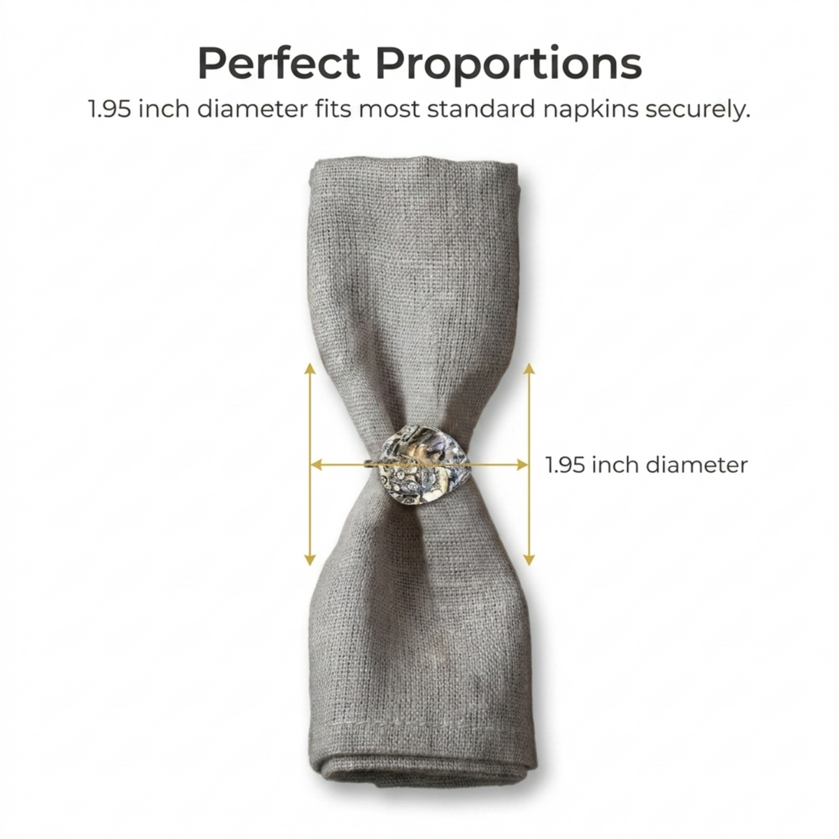 a gray napkin with a decorative silver button on it, and the napkin is folded in half to demonstrate the perfect proportions.