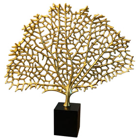 a large, intricate, and golden-colored sculpture of a tree or plant, displayed on a black base.