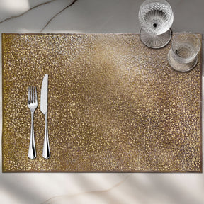 Set of six gold PVC cut-out placemats with intricate designs, ideal for protecting tables and enhancing dining decor.