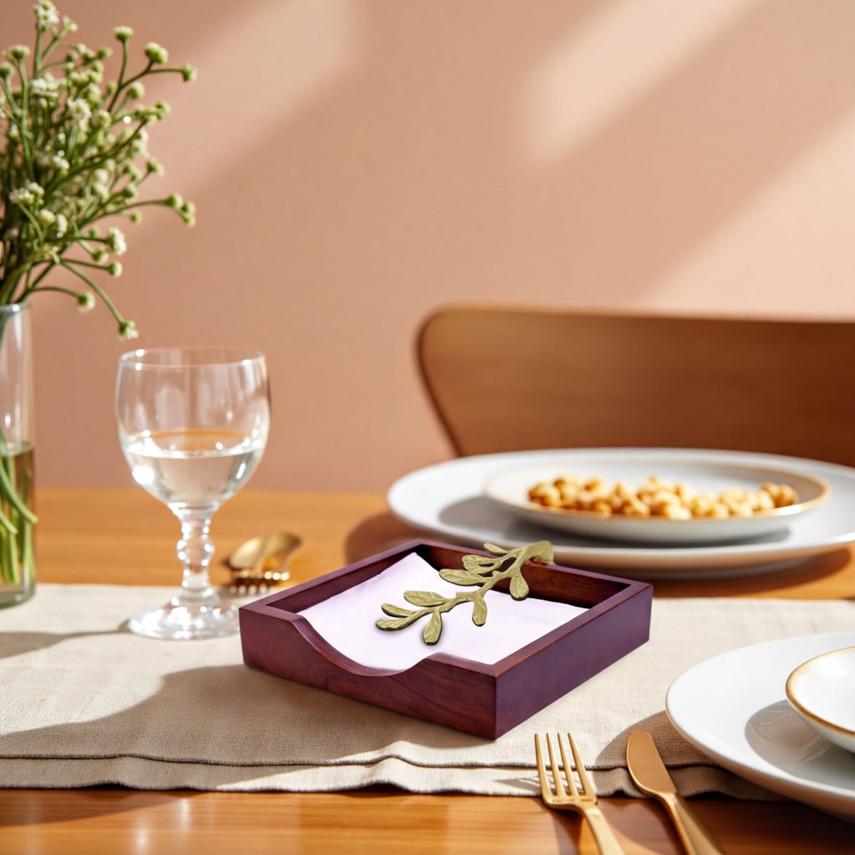 Solid wood napkin holder with gold-finish ornament, stylish napkin dispenser for elegant table settings.