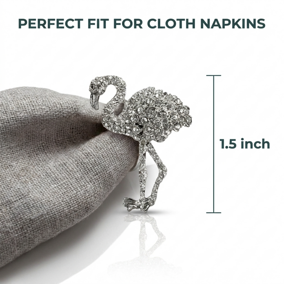 A silver rhinoceros-shaped napkin holder with rhinoceros figurine on top, placed on a grey fabric background.