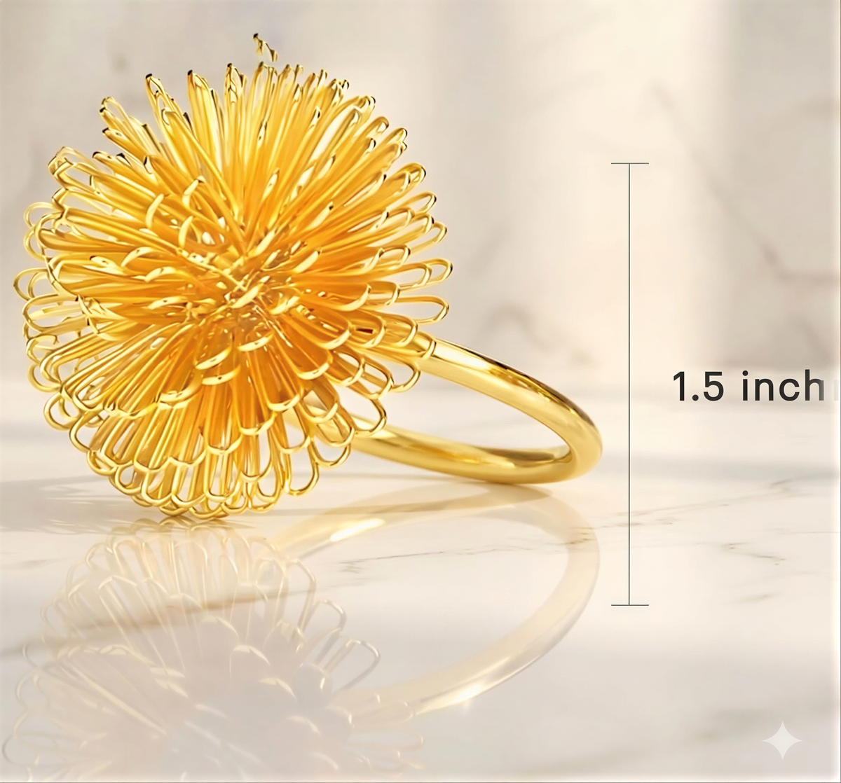 A golden ring with a large, intricate flower-like design on it, placed on a marble surface.