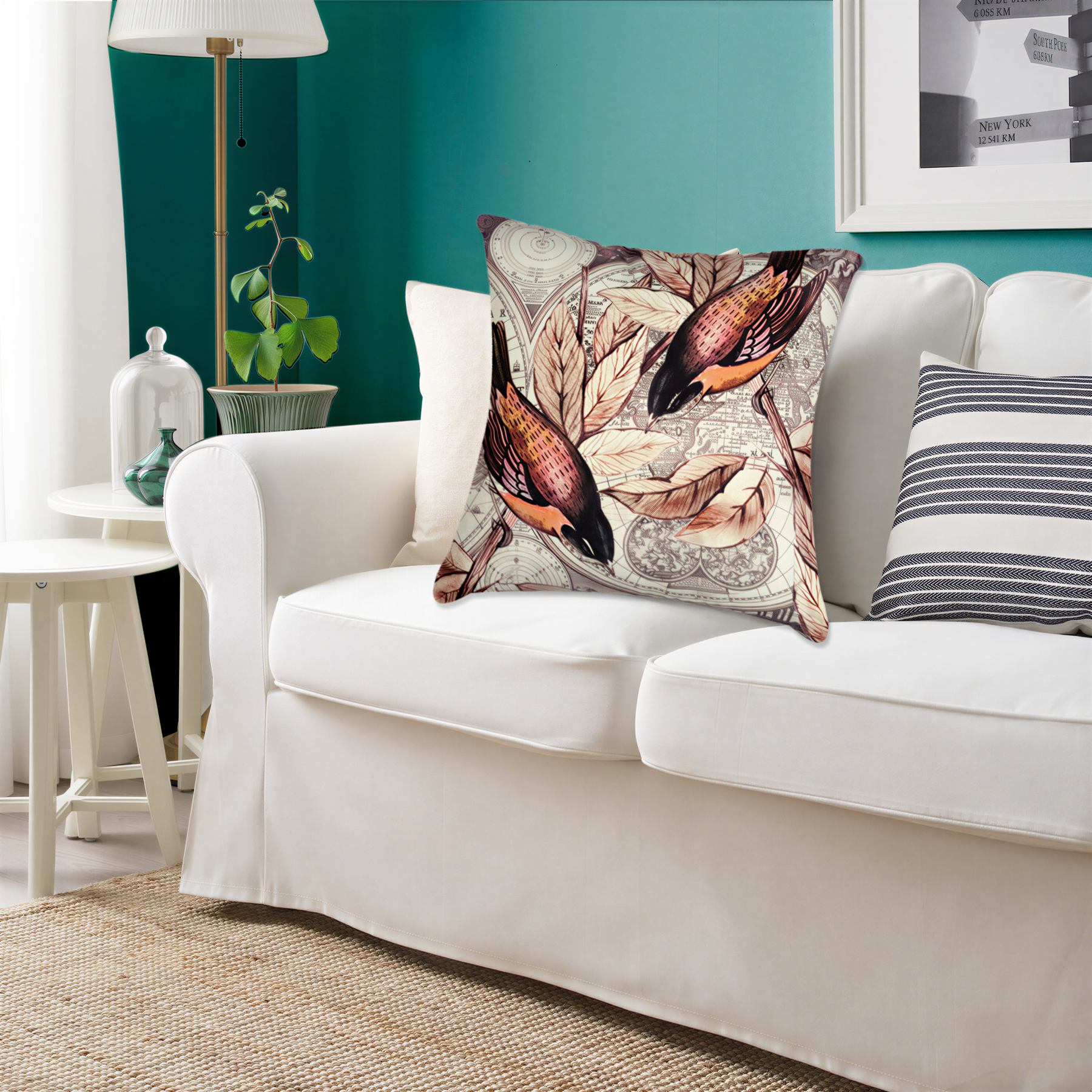 a living room with a white sofa adorned with a decorative pillow featuring a bird design. The room has a green wall, a lamp, and a plant, creating a cozy and inviting atmosphere.