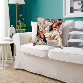 a living room with a white sofa adorned with a decorative pillow featuring a bird design. The room has a green wall, a lamp, and a plant, creating a cozy and inviting atmosphere.