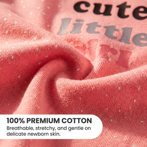 a close-up view of a soft, pink fabric with small white dots, likely representing the fabric's texture.