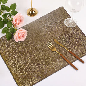 Set of six gold PVC cut out placemats with intricate designs, ideal for protecting surfaces and enhancing table decor.