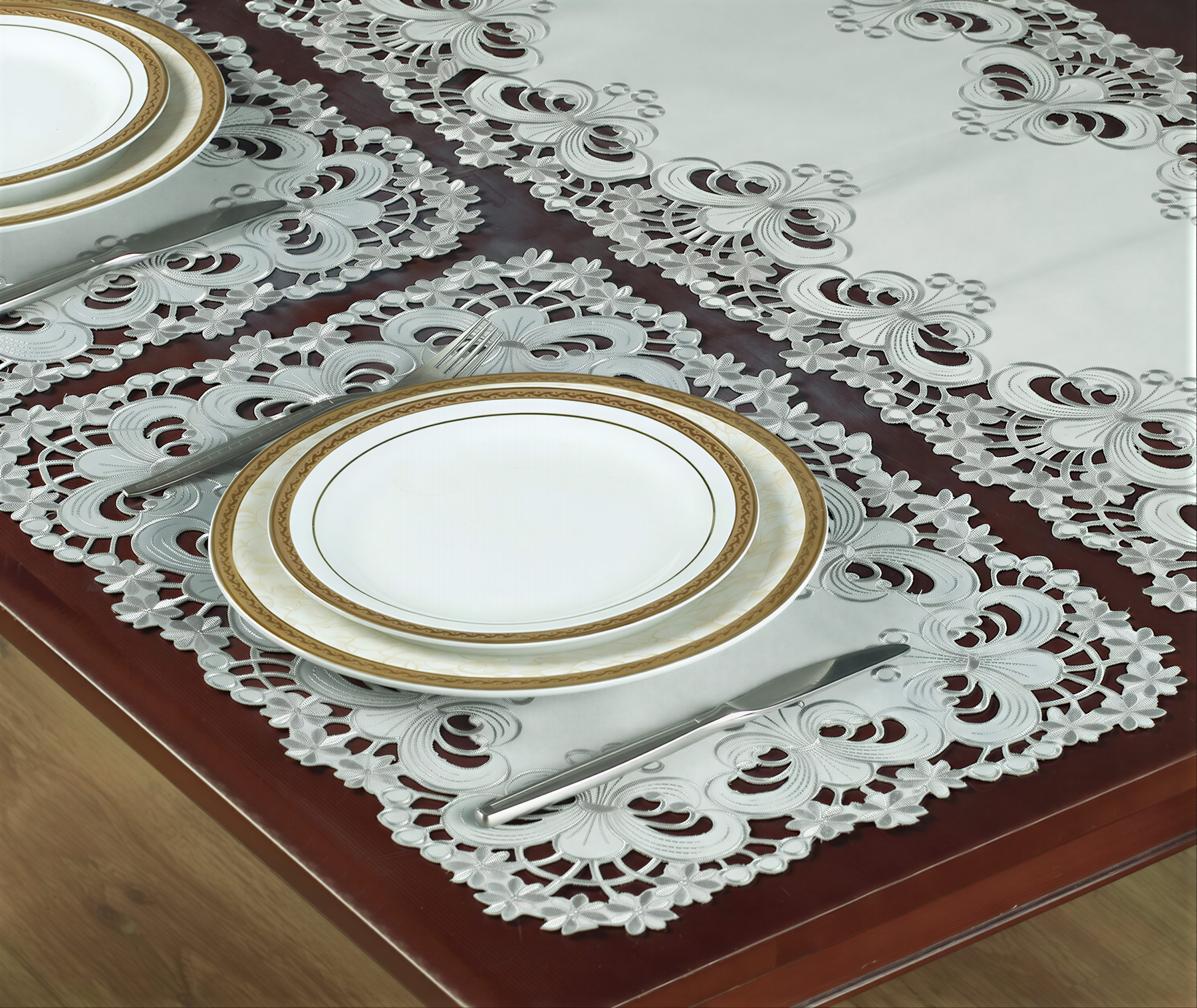 Set of six linen placemats with European embroidery from the Creola Collection, featuring intricate floral designs.