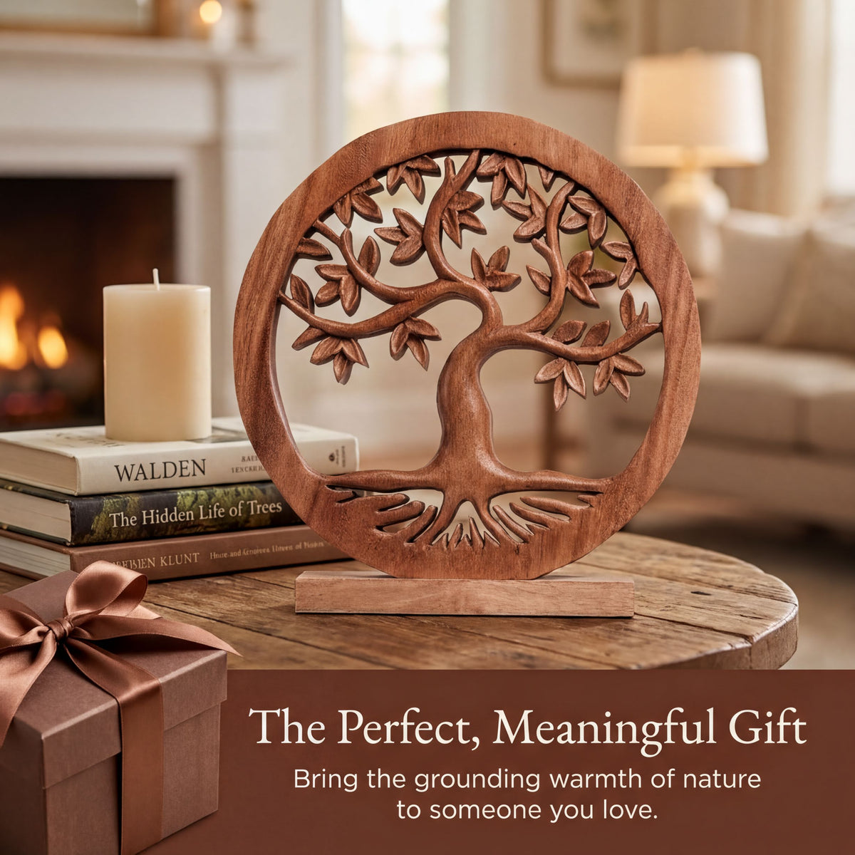 a wooden tree-shaped ornament on a wooden table, with a stack of books and a gift box nearby. The scene is set in a cozy living room with a fireplace visible in the background.