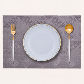 Set of four PVC placemats for dining table, with colorful, textured surface for protection and decoration.