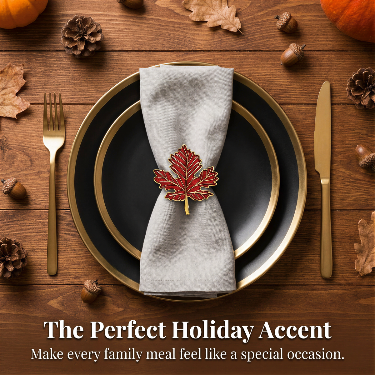 a table setting with a black plate, a gold rim, and a white napkin with a red maple leaf napkin ring. The table is decorated with autumn leaves, pine cones, and acorns.