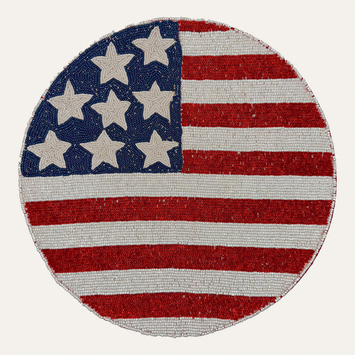 Set of two beaded USA flag round placemats featuring patriotic red, white, and blue star accents, perfect for American-themed dining.