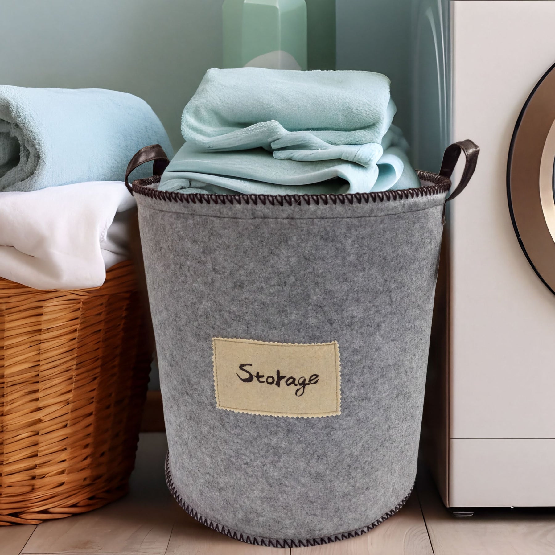 Set of three gray felt laundry hampers and storage bins from 4629, featuring soft handles and spacious interior for laundry and organization.