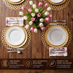 a beautifully set dining table with a vase of pink and white tulips, gold place mats, and place settings with white plates and gold rims.