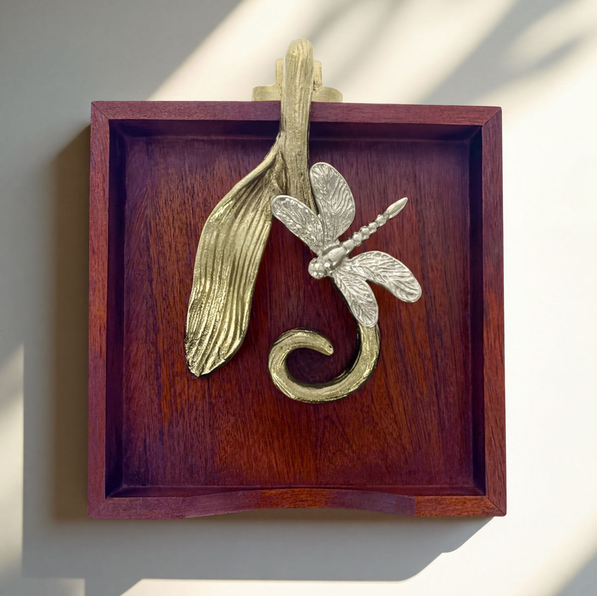 Solid wood napkin holder with silver and gold finish ornament, stylish dispenser for table or countertop use.