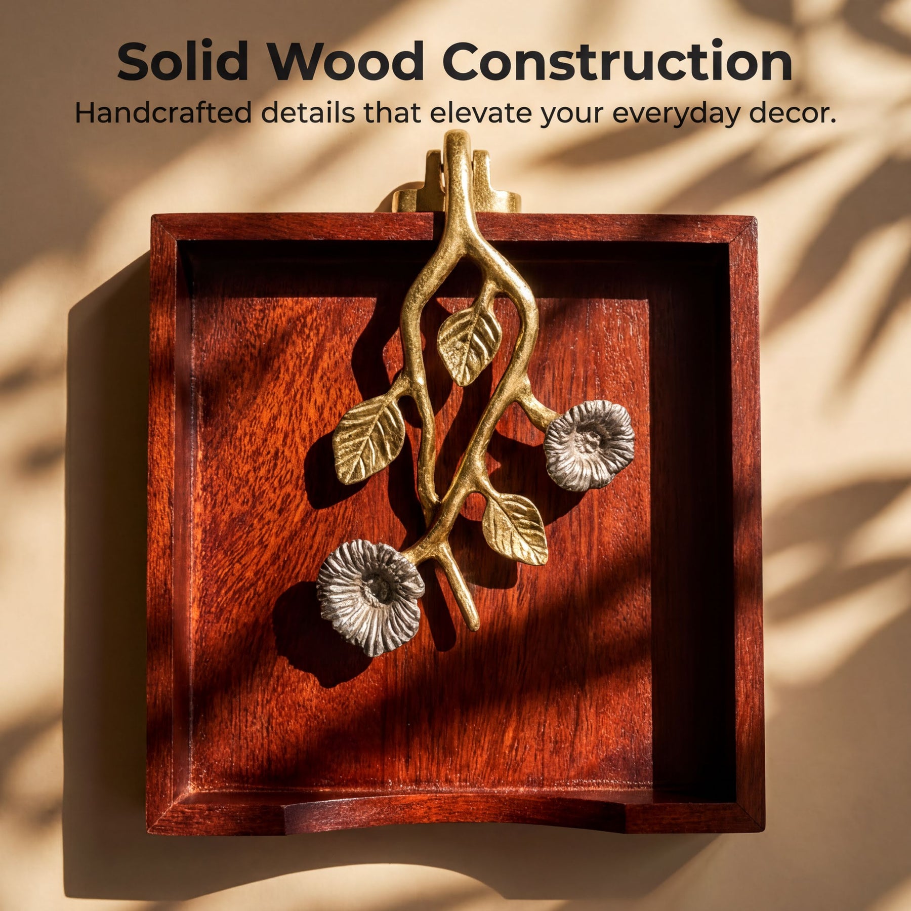 a wooden tray with a decorative metal piece hanging on it, which appears to be a piece of solid wood construction.