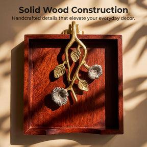 a wooden tray with a decorative metal piece hanging on it, which appears to be a piece of solid wood construction.