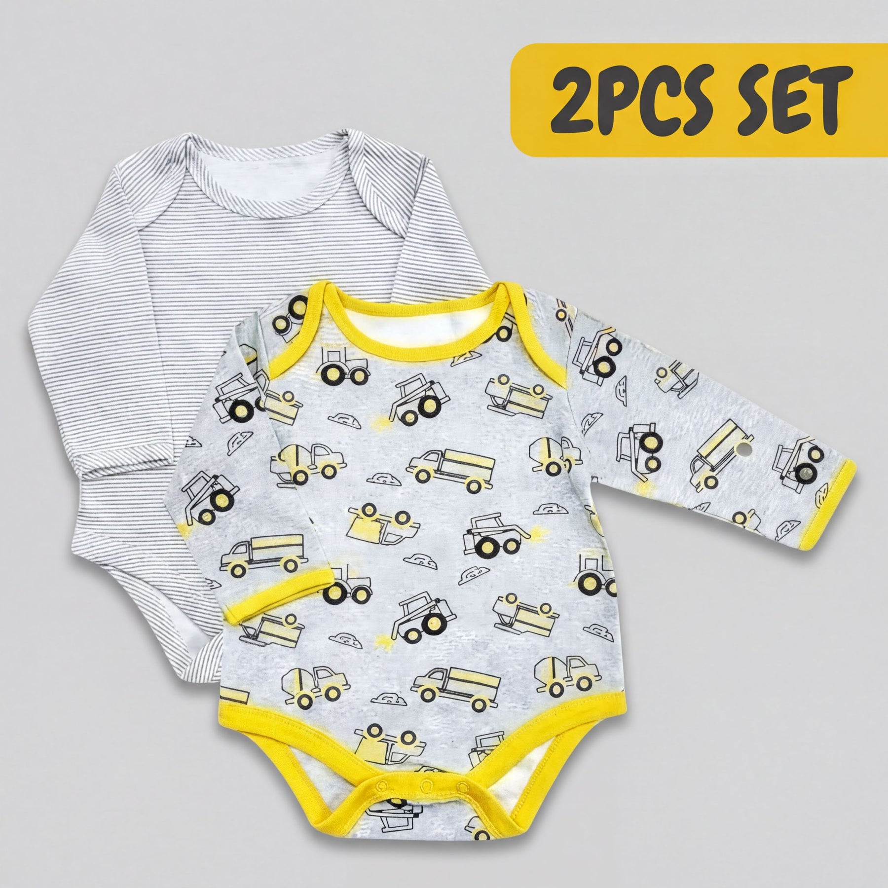 A set of two baby onesies, one with a grey and yellow truck pattern and the other with a white and black striped pattern.