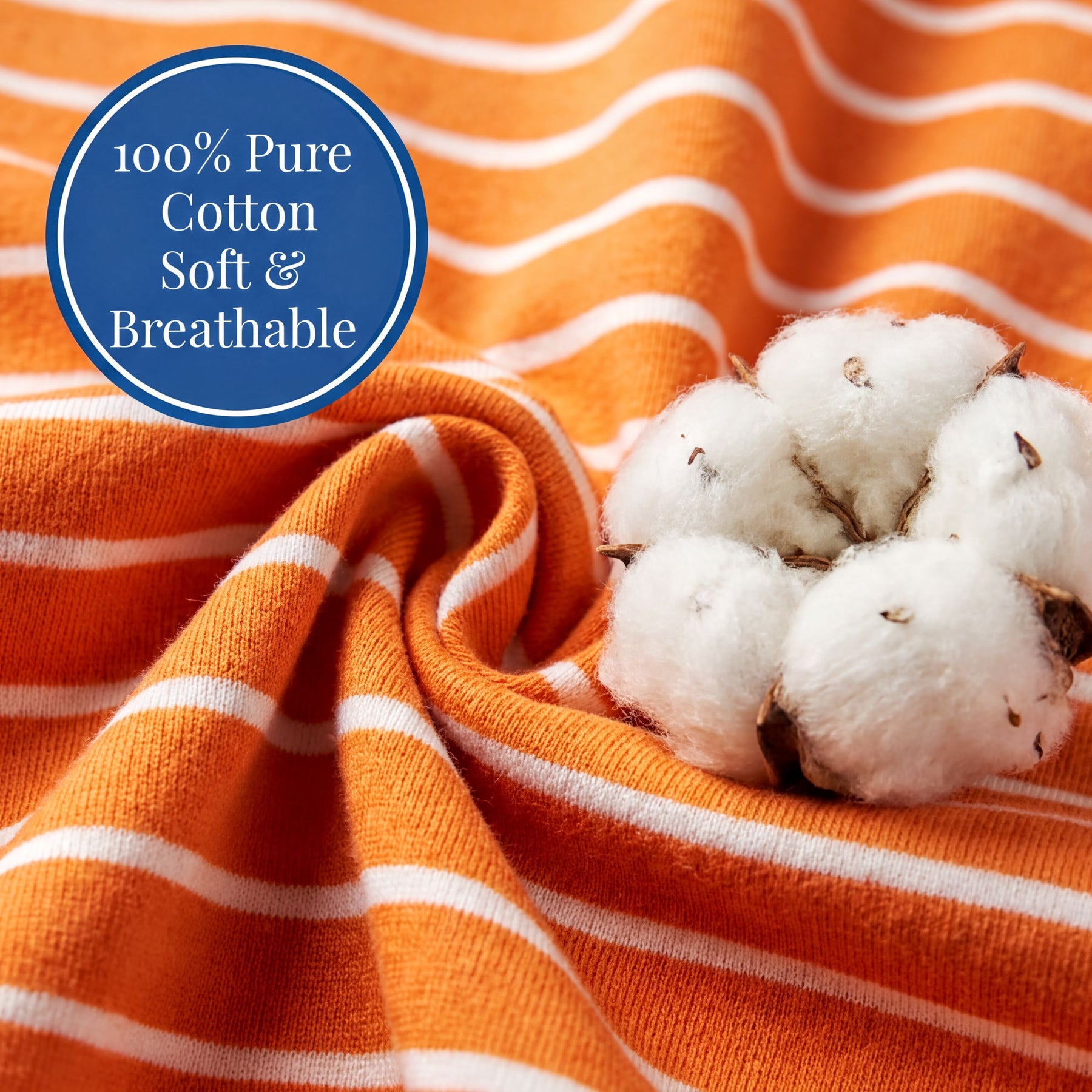 a close-up view of a soft and breathable orange and white striped fabric, with a cluster of fluffy white cotton balls resting on top of it.