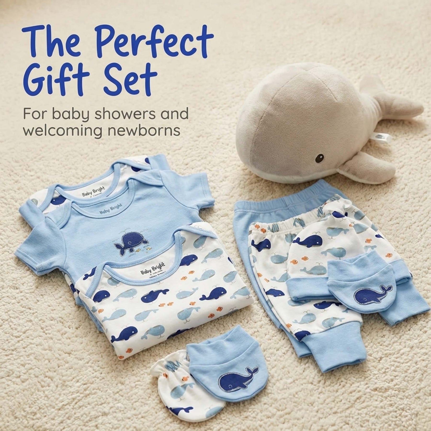 A gift set for a baby shower, including baby clothes, a stuffed whale, and baby accessories.