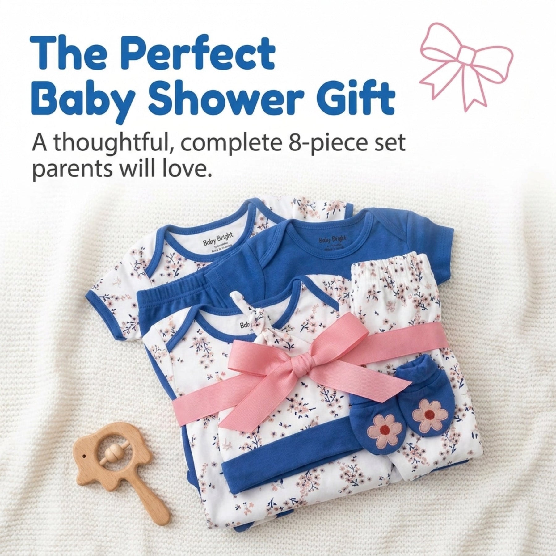 a set of baby clothes and accessories, including a blue onesie, a pink bow, and a wooden baby rattle, arranged on a white background.