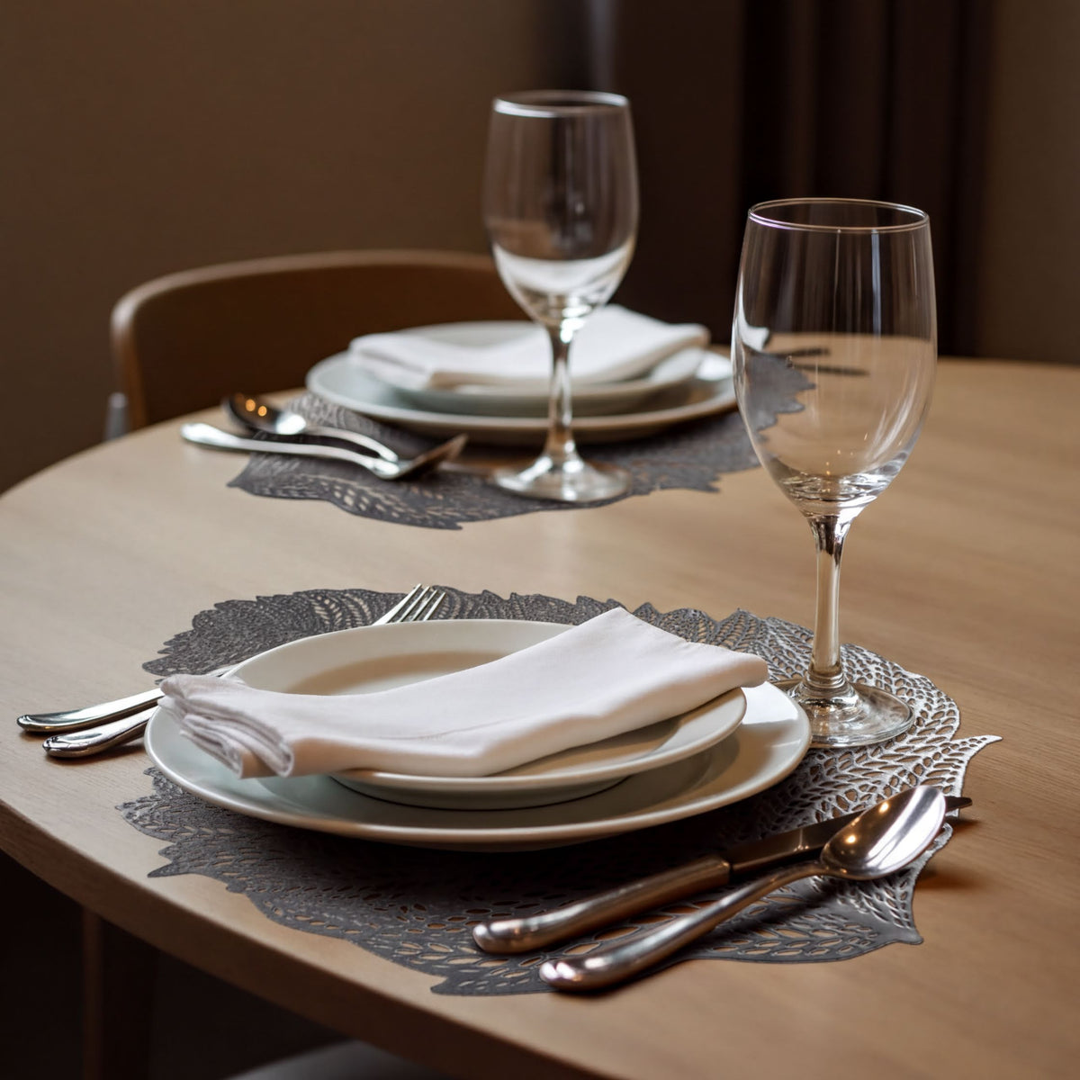 Set of six leaf cut out vinyl placemats by AMF033-SLV, decorative tableware with elegant leaf-shaped cutouts.