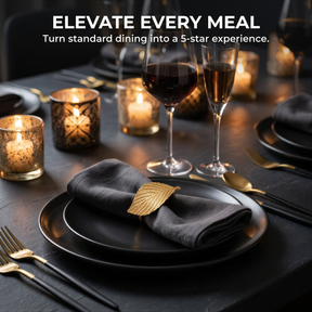 a table set with a black tablecloth, plates, wine glasses, and candles, creating an elegant and sophisticated dining atmosphere.
