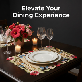 a table set for a meal, with a floral centerpiece, wine glasses, plates, and cutlery arranged neatly.