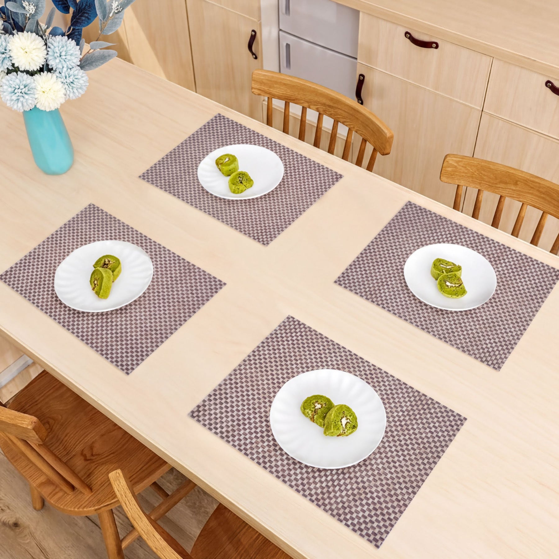 Set of four PVC placemats for dining table, durable and spill-resistant, perfect for protecting your tabletop during meals.