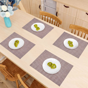 Set of four PVC placemats for dining table, durable and spill-resistant, perfect for protecting your tabletop during meals.