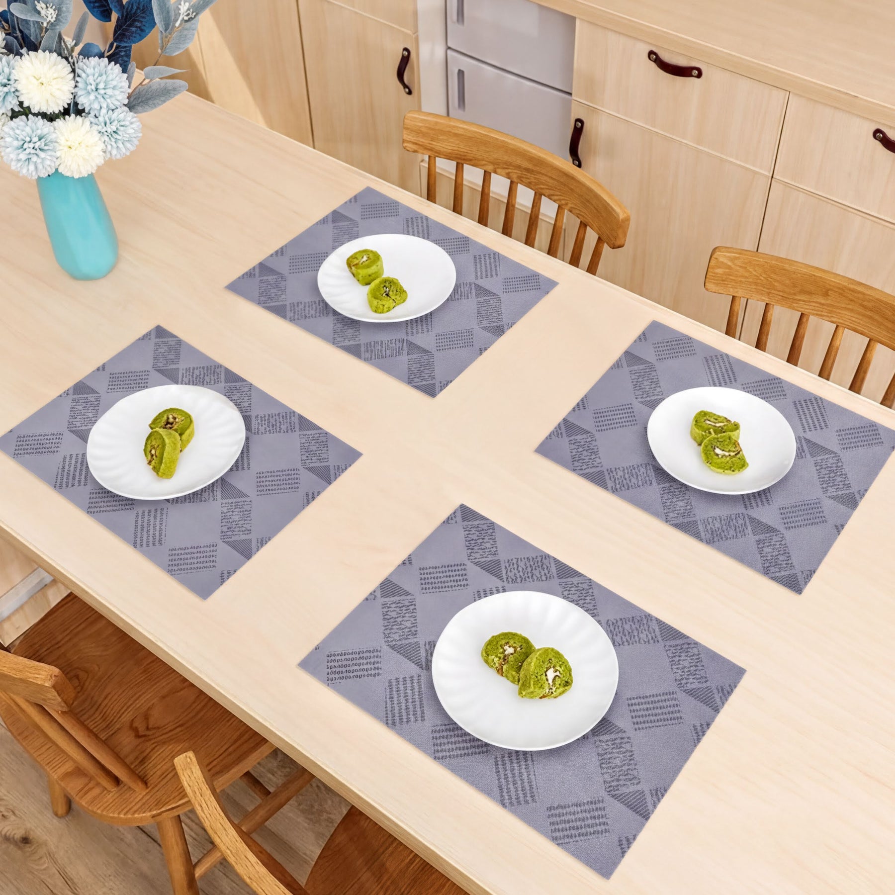Set of four PVC placemats for dining table, durable and easy to clean, ideal for protecting surfaces during meals.