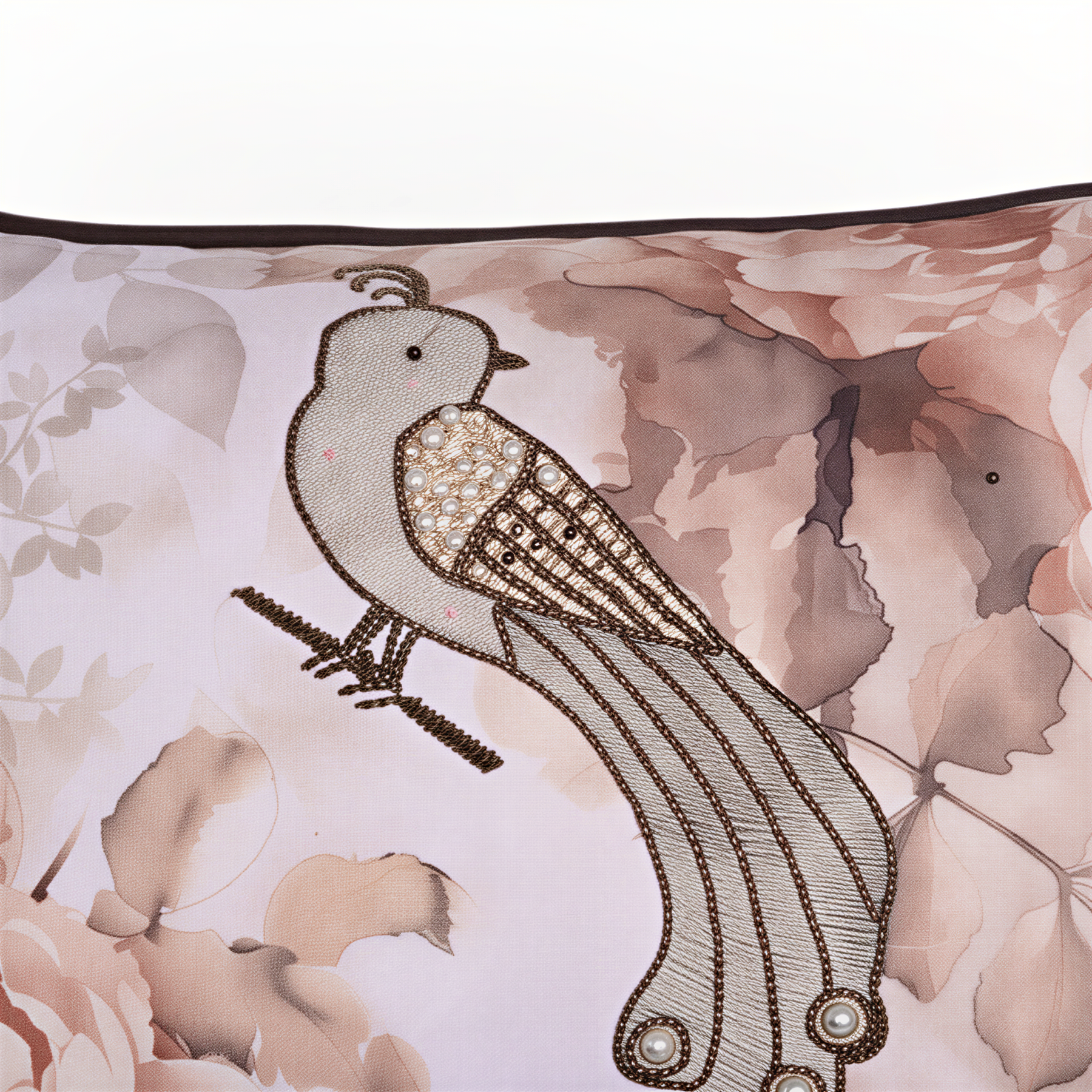 a close-up of a decorative bird embroidered on a fabric with a floral pattern.