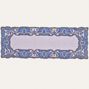 White and blue beaded table runner by RNR, 54 inches long and 13 inches wide, with intricate bead detailing on fabric.
