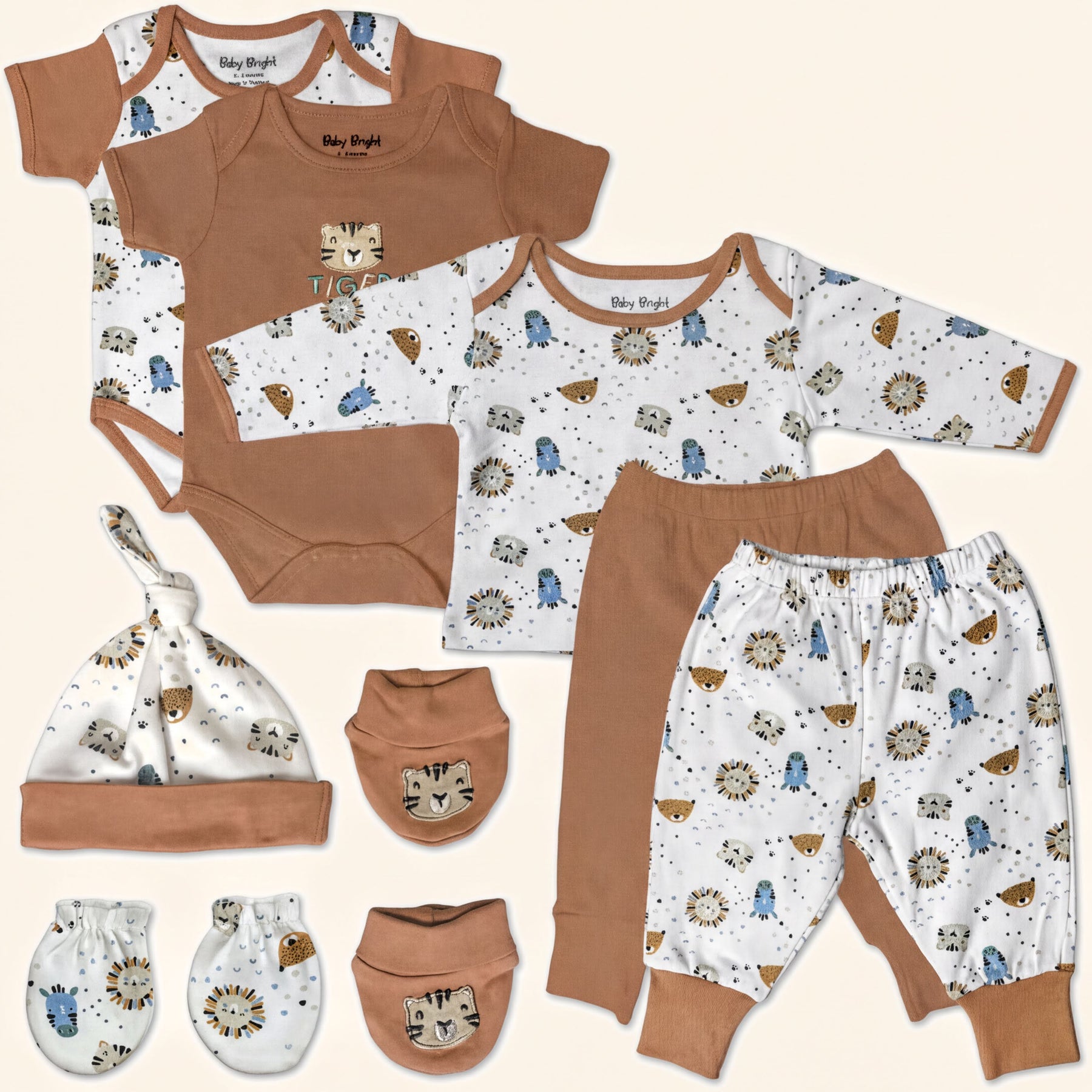 A collection of baby clothing and accessories, including onesies, pants, a hat, and mittens, all featuring animal print designs in brown and white.