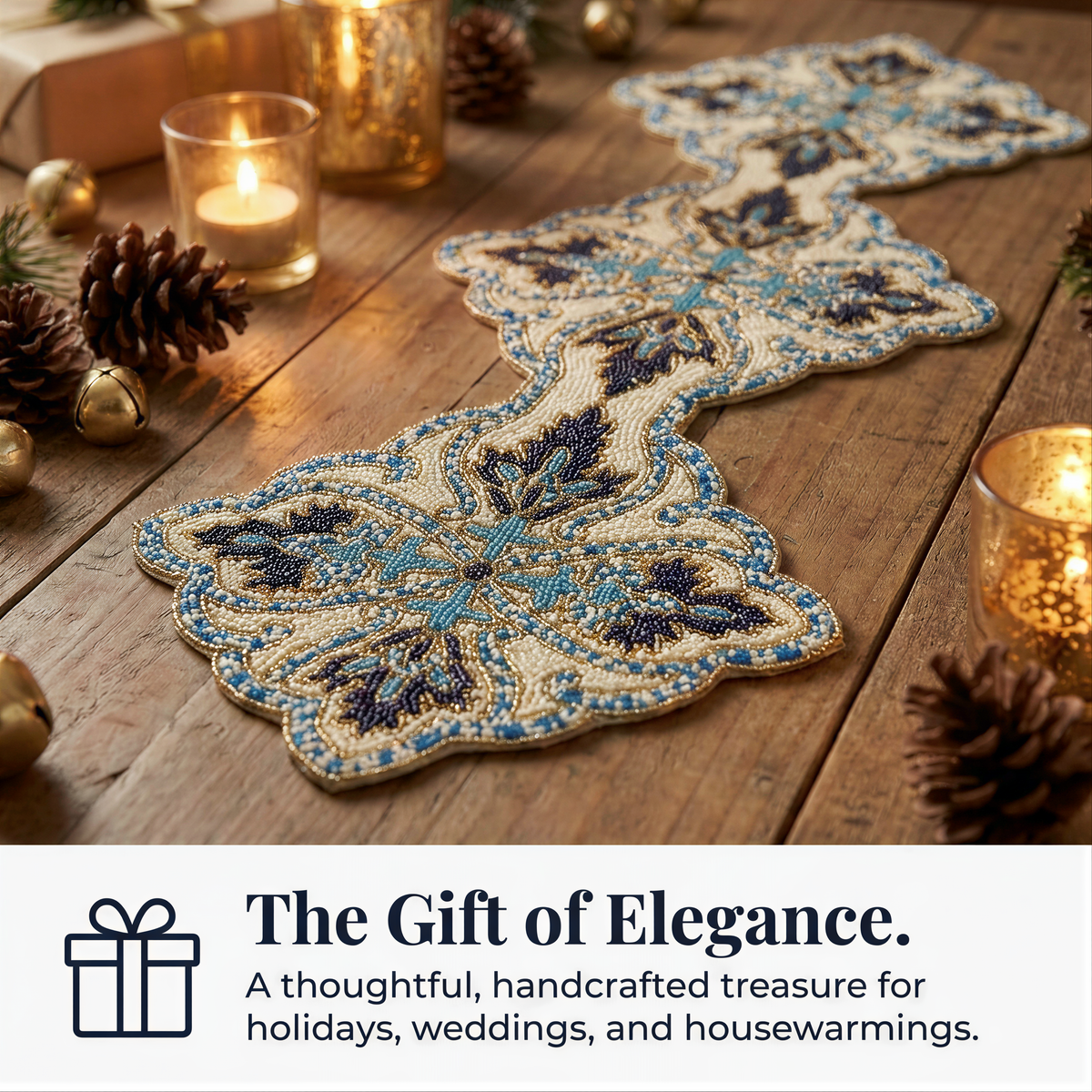 a decorative table runner with intricate blue and white floral patterns, surrounded by pine cones, candles, and other holiday decorations, creating a festive and elegant atmosphere.