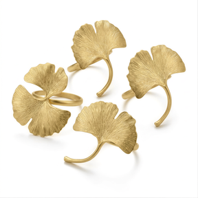 a collection of gold-colored metal rings with leaf-like designs, arranged in a circular pattern.